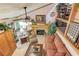 Comfortable living room featuring a stone fireplace, ceiling fan, and rustic decor elements at 5494 Princeton Oaks Ln, Sugar Hill, GA 30518