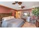 Bedroom suite with a ceiling fan, wood flooring, and stylish decor at 5494 Princeton Oaks Ln, Sugar Hill, GA 30518
