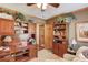 Inviting home office with wood desk, built-in shelves, and comfortable seating at 5494 Princeton Oaks Ln, Sugar Hill, GA 30518
