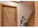 Stairway with chair lift, a barn door, and natural wood trim at 5494 Princeton Oaks Ln, Sugar Hill, GA 30518