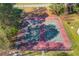 Aerial view of two well-maintained tennis courts surrounded by trees at 5494 Princeton Oaks Ln, Sugar Hill, GA 30518