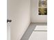 A bright bedroom featuring a white door and a large window at 8229 Coldstream Dr, Fairburn, GA 30213