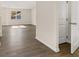 Bright living room with wood-look flooring and large window providing natural light at 8229 Coldstream Dr, Fairburn, GA 30213