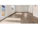 Light-filled living area with wood-look floors and large windows providing natural light at 8229 Coldstream Dr, Fairburn, GA 30213