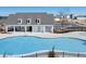 Gorgeous community pool with a large deck, outdoor seating, and a fenced perimeter at 8229 Coldstream Dr, Fairburn, GA 30213