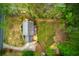 Aerial shot of house with a spacious yard, deck with furniture, driveway, and mature trees at 240 Pinebrook Way, Roswell, GA 30076
