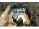Aerial view of a community pool and tennis court surrounded by trees, offering recreational amenities at 240 Pinebrook Way, Roswell, GA 30076