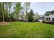 Large backyard with a pergola-covered seating area, perfect for outdoor relaxation and gatherings at 240 Pinebrook Way, Roswell, GA 30076