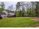 Spacious backyard with a well-maintained lawn, mature trees, and a charming deck, perfect for outdoor enjoyment at 240 Pinebrook Way, Roswell, GA 30076