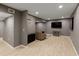 Spacious finished basement area with a flat screen television, a comfortable chair, and neutral-toned walls at 240 Pinebrook Way, Roswell, GA 30076