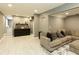 A finished basement area with a sectional sofa, dark accent cabinet with wet bar and a basketball hoop, great for entertaining at 240 Pinebrook Way, Roswell, GA 30076