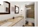 Double vanity bathroom with updated countertops and wood-look tile shower at 240 Pinebrook Way, Roswell, GA 30076