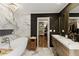 Primary bathroom with freestanding tub, marble tile, double vanity, and walk-in closet at 240 Pinebrook Way, Roswell, GA 30076
