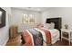 Bedroom with hardwood floors, modern decor, and a comfortable bed at 240 Pinebrook Way, Roswell, GA 30076