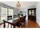 Cozy dining room offering hardwood floors, a large window with natural light, and a stylish china cabinet at 240 Pinebrook Way, Roswell, GA 30076