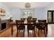 Classic dining room featuring hardwood floors, a large table with seating for eight, and a stylish light fixture at 240 Pinebrook Way, Roswell, GA 30076