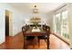 Bright dining room with hardwood floors, chandelier, and natural light, perfect for Gathering gatherings and entertaining guests at 240 Pinebrook Way, Roswell, GA 30076