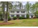 Charming two-story home featuring a manicured front lawn and traditional architectural details at 240 Pinebrook Way, Roswell, GA 30076