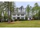 Traditional home nestled among mature trees, creating a sense of privacy and tranquility at 240 Pinebrook Way, Roswell, GA 30076
