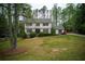 Classic colonial home with lush green lawn and mature trees, offering a serene setting at 240 Pinebrook Way, Roswell, GA 30076
