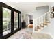Charming foyer with tile flooring, black french doors, staircase, and plenty of natural light for a warm and inviting atmosphere at 240 Pinebrook Way, Roswell, GA 30076