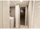 Hallway view of a tiled walk-in shower, washer, and dryer within a modern home layout at 240 Pinebrook Way, Roswell, GA 30076