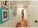 Bright hallway featuring hardwood floors and gallery wall to next room at 240 Pinebrook Way, Roswell, GA 30076