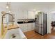 Bright kitchen featuring stainless steel appliances, butcher block countertop, white cabinets, and modern lighting at 240 Pinebrook Way, Roswell, GA 30076