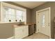 A modern kitchen featuring a stainless steel sink, butcher block counters, and bright natural light from the window at 240 Pinebrook Way, Roswell, GA 30076