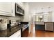 Modern kitchen featuring stainless steel appliances, white cabinetry, and a butcher block island overlooking a dining area at 240 Pinebrook Way, Roswell, GA 30076