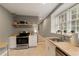 A fully-equipped modern kitchen with stainless steel appliances, butcher block countertops, and a bright window at 240 Pinebrook Way, Roswell, GA 30076