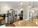 Stylish kitchen with stainless steel appliances, butcher block island, and modern pendant lighting at 240 Pinebrook Way, Roswell, GA 30076