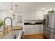 Well-lit kitchen with white cabinets, granite countertops, stainless steel appliances, and hardwood floors at 240 Pinebrook Way, Roswell, GA 30076