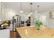 Bright kitchen features stainless steel appliances, white cabinets, and a butcher block island with pendant lighting at 240 Pinebrook Way, Roswell, GA 30076