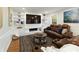 Inviting living room boasts a fireplace, a large TV, and comfortable leather seating at 240 Pinebrook Way, Roswell, GA 30076