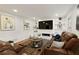 Spacious living room with fireplace, TV, and comfortable leather seating at 240 Pinebrook Way, Roswell, GA 30076