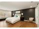 Beautiful main bedroom with black accent wall, large bed, and big window at 240 Pinebrook Way, Roswell, GA 30076