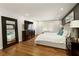 Spacious main bedroom with dark accent wall, hardwood floors, and lots of light at 240 Pinebrook Way, Roswell, GA 30076