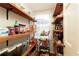 Organized pantry with wood shelving offering ample storage near a bright window at 240 Pinebrook Way, Roswell, GA 30076