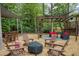 Backyard seating area featuring a pergola, comfortable seating, and outdoor decorations, ideal for gatherings at 240 Pinebrook Way, Roswell, GA 30076
