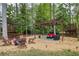 Inviting pergola area with Adirondack chairs, a fire pit, and cozy seating for outdoor gatherings at 240 Pinebrook Way, Roswell, GA 30076