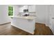Open kitchen featuring a large island, white cabinets, stainless steel appliances, and granite countertops at 8227 Coldstream Dr, Fairburn, GA 30213