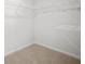 A walk-in closet is shown with wire shelving on the walls at 8227 Coldstream Dr, Fairburn, GA 30213
