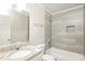 Clean bathroom with granite counters and tiled tub surround at 7127 Riverside Dr, Atlanta, GA 30328