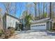 Charming two-story home with a two car garage and landscaped front yard at 7127 Riverside Dr, Atlanta, GA 30328