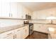 Modern kitchen with white cabinets, granite countertops, stainless steel appliances, and subway tile backsplash at 7127 Riverside Dr, Atlanta, GA 30328
