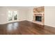 Bright living room featuring a stone fireplace, hardwood floors, and access to the outdoor deck at 7127 Riverside Dr, Atlanta, GA 30328