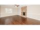 Large living room featuring wood floors and a stone fireplace at 7127 Riverside Dr, Atlanta, GA 30328
