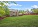 Large, well-maintained backyard with a red fence, providing ample space for recreation at 5143 Olive Branch Cir, Powder Springs, GA 30127