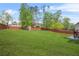 Expansive backyard featuring a storage shed and partially-covered patio at 5143 Olive Branch Cir, Powder Springs, GA 30127